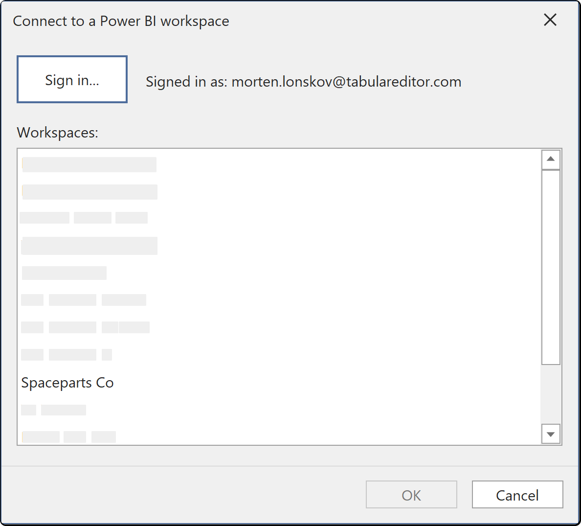 The Connect to a Power BI workspace dialog, listing the workspaces the signed-in account belongs to
